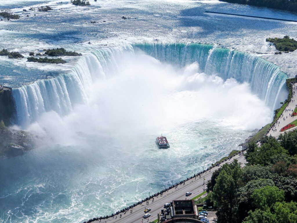 Aerial view of the "Horseshoe Falls" and the Hornblower Niagara Cruises boat in Niagara Falls, Canada. View from Skylon Tower.